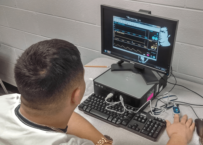 Students capturing their PPG pulses with a pulse oximeter connected to a computer.