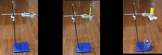 Left photo shows a support stand with base and a cork lined burette clamp.  Center photo shows the same support stand with base and a cork lined burette clamp holding a 50-ml plastic graduated cylinder. Right photo shows the same support stand with base and a cork lined burette clamp holding a 50-ml plastic graduated cylinder. The graduated cylinder is covered with organza fabric held in place by a rubber band.