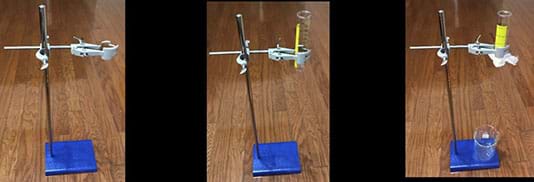 Left photo shows a support stand with base and a cork lined burette clamp.  Center photo shows the same support stand with base and a cork lined burette clamp holding a 50-ml plastic graduated cylinder. Right photo shows the same support stand with base and a cork lined burette clamp holding a 50-ml plastic graduated cylinder. The graduated cylinder is covered with organza fabric held in place by a rubber band.