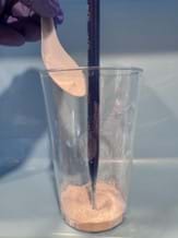A photo showing the baking soda at the bottom of the cup and colored vinegar in the dropper setup prior to layering the clay, gravel, and sand. A photo showing the baking soda at the bottom of the cup and colored vinegar in the dropper setup prior to layering the clay, gravel, and sand.