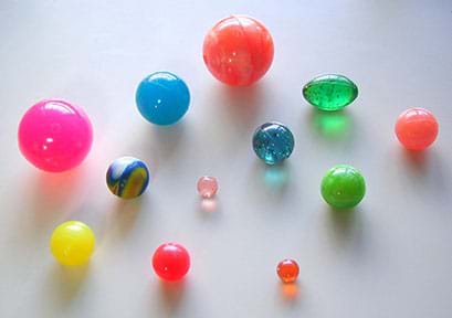 An assortment of colorful rubber balls of different sizes.