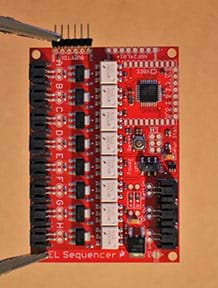 A photograph shows the EL sequencer, a red circuit board, with header pins soldered to the top left corner pinholes.