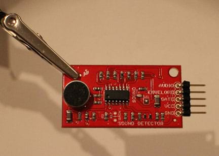 A photograph shows the sound detector, a small red circuit board, with header pins soldered to the right side pin holes.