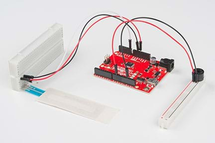 A photograph shows the activity setup. On the left, a potentiometer is plugged into the larger part of a cut breadboard with three wires (red, black and white) leading to the RedBoard (center). Two different wires (red and black, respectively) connected to the RedBoard then lead to a speaker plugged into the smaller, cut-off portion of the breadboard (located on the right).