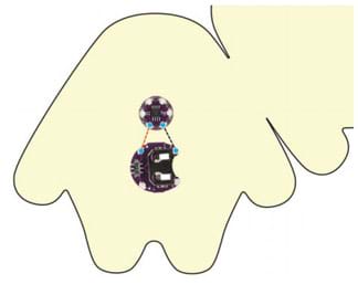A diagram shows the LilyTiny board and battery holder in the center of one side of the monster template felt cutout (same as Figure 1) plus dashed lines showing the sewn circuit made with conductive thread stitches. Dashed red lines indicate the stitches that connect the positive pins; dashed black lines indicate the stitches that connect the positive pins.