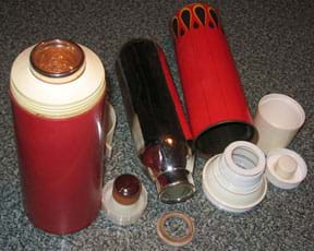 A photograph shows two insulated thermos bottles. One is ready for use. The other is disassembled to show the inner vacuum flask (mirror-finished glass container) and various other parts (outer sleeve, screw lids, cup and gasket).