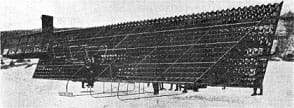 A black and white photograph shows a truss-like wing structure composed entirely of thousands of open tetrahedrons—a mass of 3D triangle shapes.