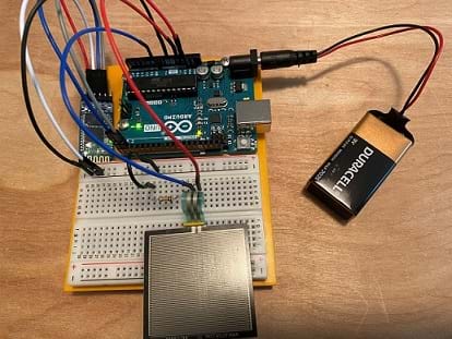 The same circuit as previous with the addition of an HC-05 Bluetooth module and a 9-volt battery connected to the Arduino barrel connector.