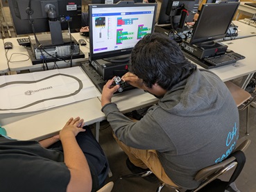 A photo showing a group working on their code for the ultimate challenge.