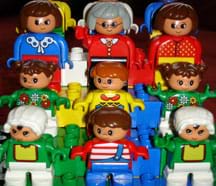 A photograph shows nine LEGO Duplo people, small and colorful toy figures.