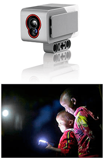 Two photos: Two boys shine a flashlight in the dark, making a dot of light on a far wall. A palm-sized white and gray plastic device shaped like a rectangular box, with two transparent bumps in an orange recessed area at one end (a color sensor).