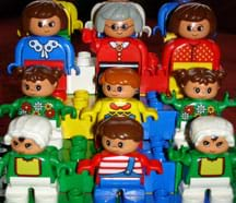 A photograph shows nine LEGO DUPLO people, small and colorful toy figures.