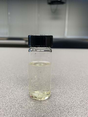 Picture of a vial of water with microplastics collected from the Pacific Ocean.