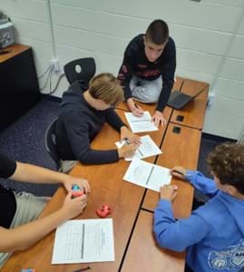A photo of students working though gate paperwork.