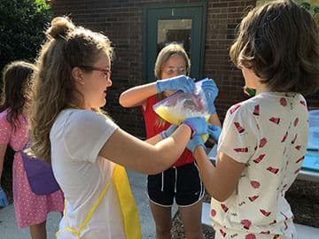 Students creating the washing machine prototype.