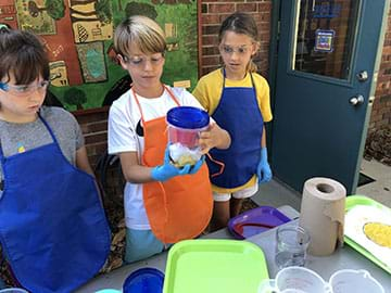 Students rinsing the rag after testing.