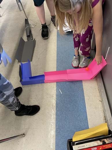 Students are encouraged to test their designs as they construct their roller coasters.