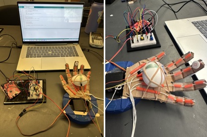 A photo of three cardboard hand designs, along with an Arduino circuit board, sitting on a table. The hands are connected by wires to the circuit.