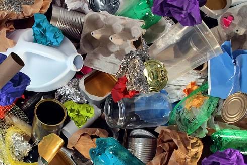 An image of recycled items such as cartons, tin, paper, plastic.
