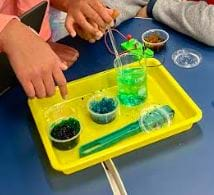 Picture of a tray containing two prepared gels and one gel in the process of being prepared in a graduated cylinder.