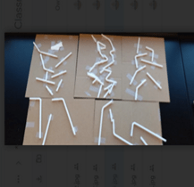 A photo showing five cardboard sheets, each featuring several white plastic drinking straws, some straight and others bent at the flexible neck, taped down with clear adhesive tape. A photo showing five cardboard sheets, each featuring several white plastic drinking straws, some straight and others bent at the flexible neck, taped down with clear adhesive tape.
