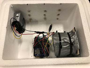 Photograph showing a small Styrofoam box housing one of the Arduinos and shielded Geiger counters.