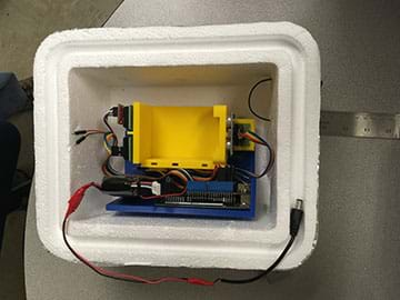 A photo of the payload experiment that measured the speed of sound by sending a signal at regular time intervals across a fixed distance.