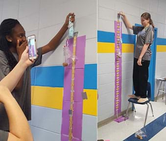 Image of two students determining the optimum stretching speed of slime using a tensile test.