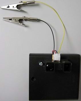 Photo shows a constructed "radar" system using a Sharp GP2Y0A02YK0F sensor and two alligator clips connected to the sensor with wires.