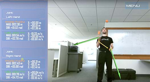 A photograph shows a student juggling three orange balls. Yellow arrows indicate the positions of his hands and green arrows indicate their velocities. To the side, a numerical display lists those quantities. 