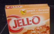 Photo shows orange box of peach-flavored JELL-O gelatin desert mix.