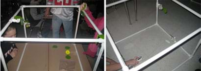 Two photos show students at cube-shaped structures made of white pipes using their hands to adjust small mirrors mounted on edging pipes, and testing to see the laser's red light reflected through a series of mirrors.