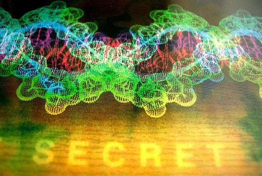 A colorful graphic depicts overlapping brightly colored DNA helixes in intermingling shades of blue, green, red and purple. In the foreground floats the word "SECRET."