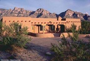 Photo of a low, wide earthen home.