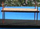 Photo shows two horizontal surfaces connected by corner sticks.