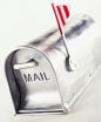 Photo shows a slivermailbox with the flag up.